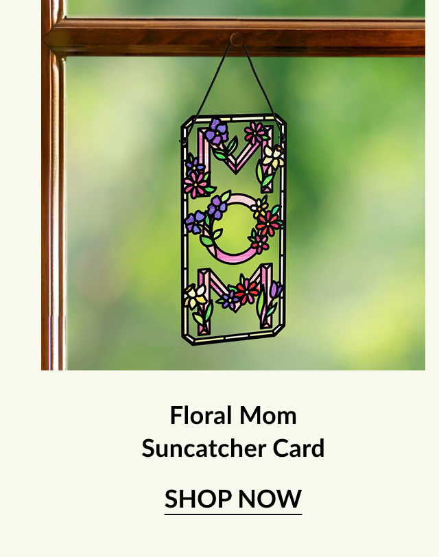 Colorful floral suncatcher card with ''MOM'' design hanging in a window, surrounded by greenery. Perfect for Mother's Day gifting.