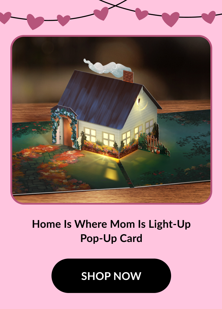 A charming pop-up card featuring a lit-up house surrounded by colorful autumn leaves, with a message celebrating home and family.
