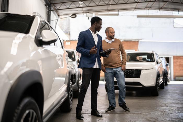 two men in a car showroom