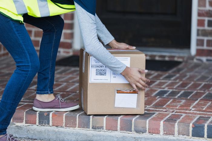 person leaving a package on a doorstep