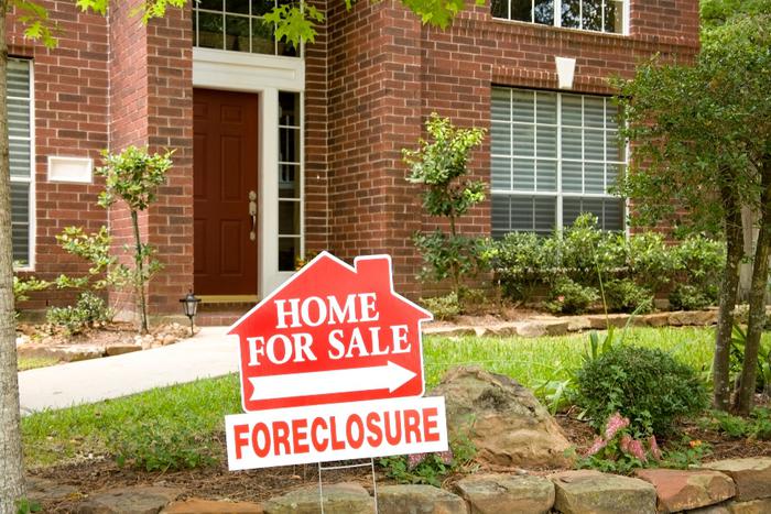House with foreclosure sign.