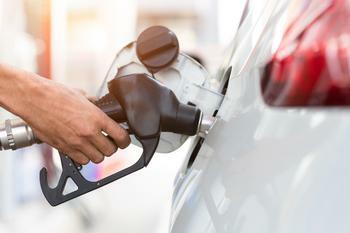 Person pumping gas.