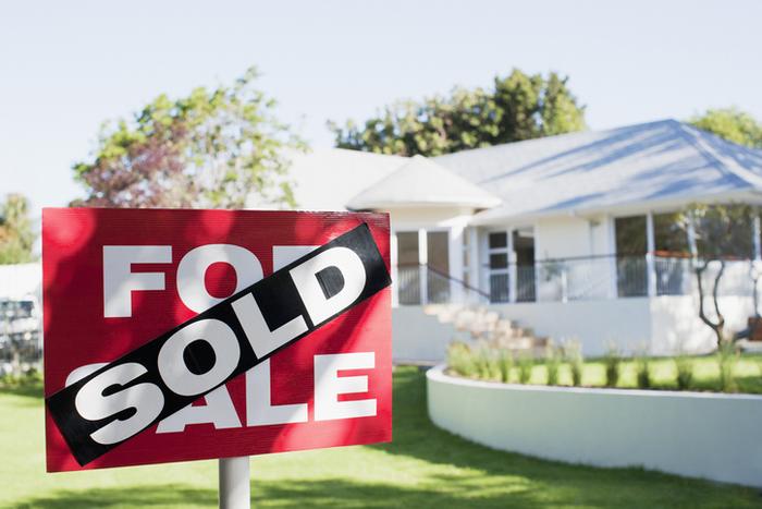 Home with sold sign in front