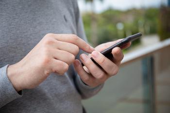 Man holding phone and texting