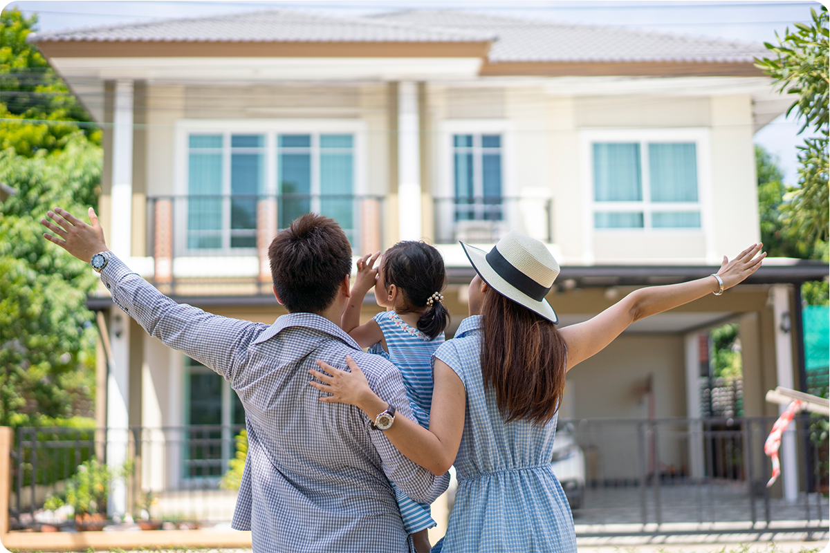 a family standing in front of their new home.