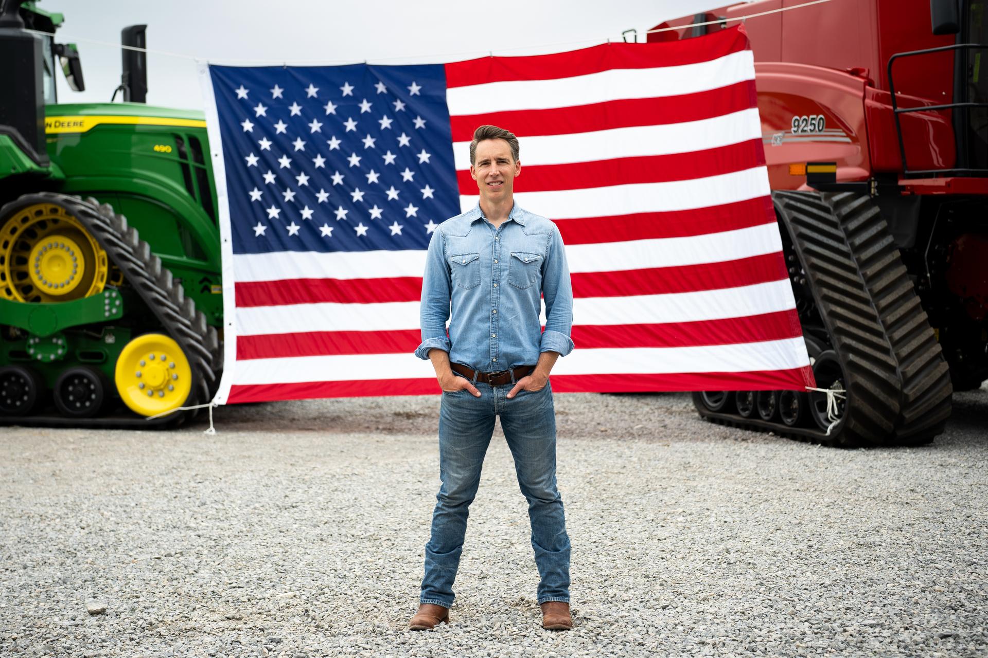 Josh Hawley in front of farm equipment 
