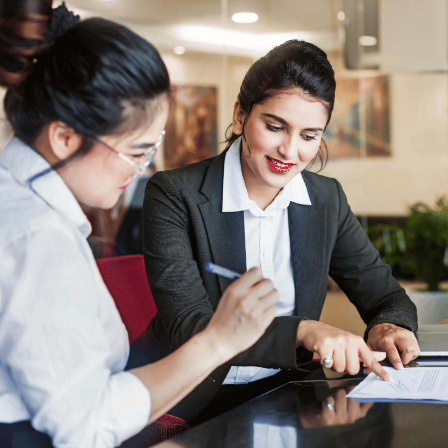 Two women signing a contract