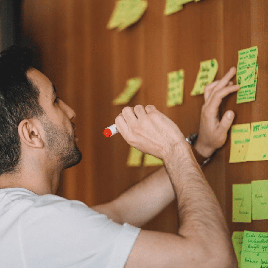 Man working on project discovery with sticky notes