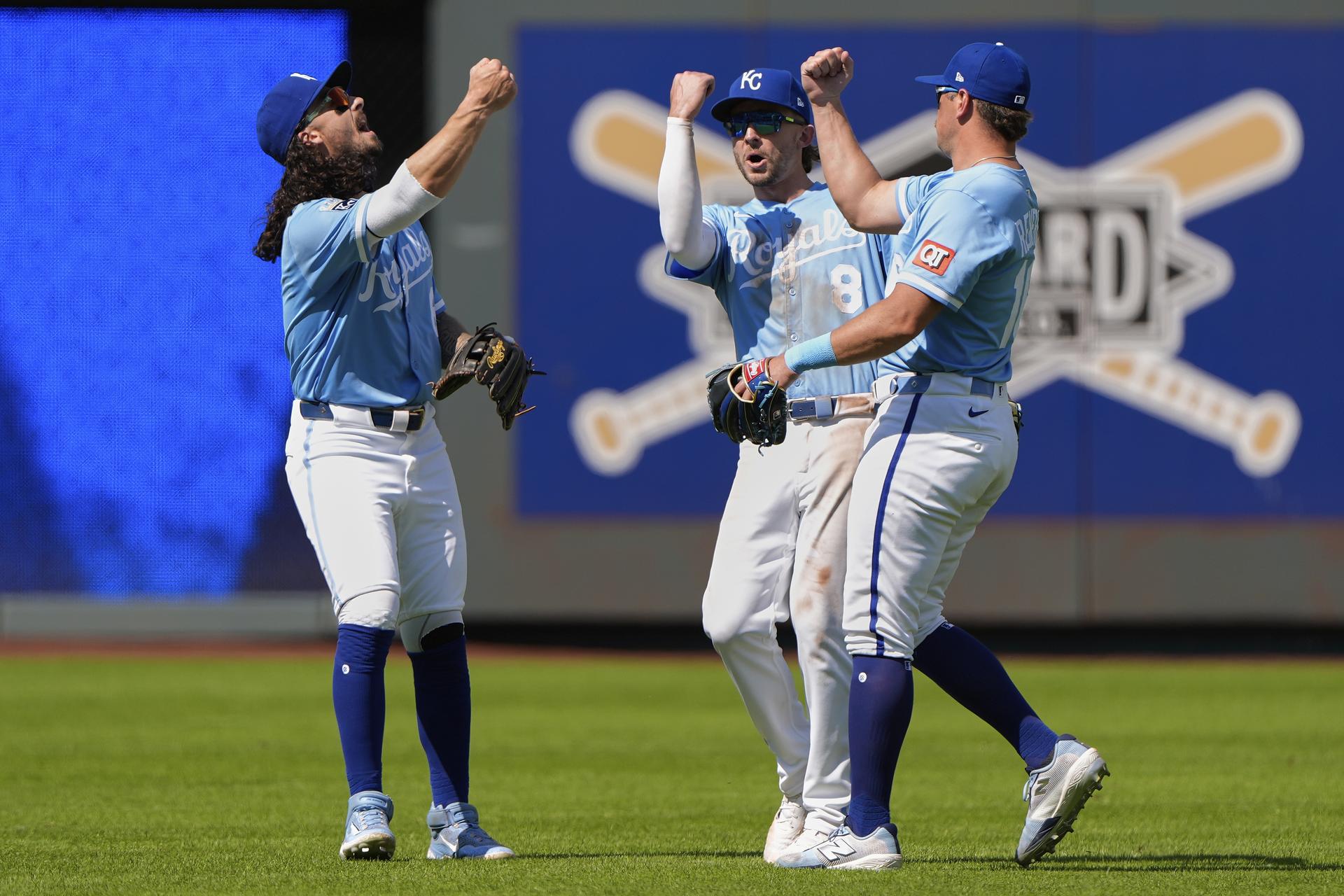 Kansas City Royals outfielders Jonathan India, left, Drew Waters (8) and Hunter Renfroe, right, celebrate a win.