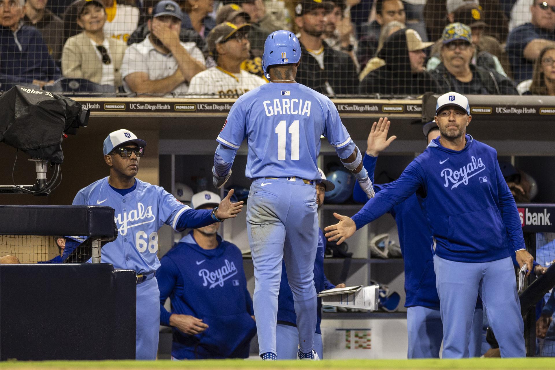 Hitting coach Alec Zumwalt high-fives Maikel Garcia