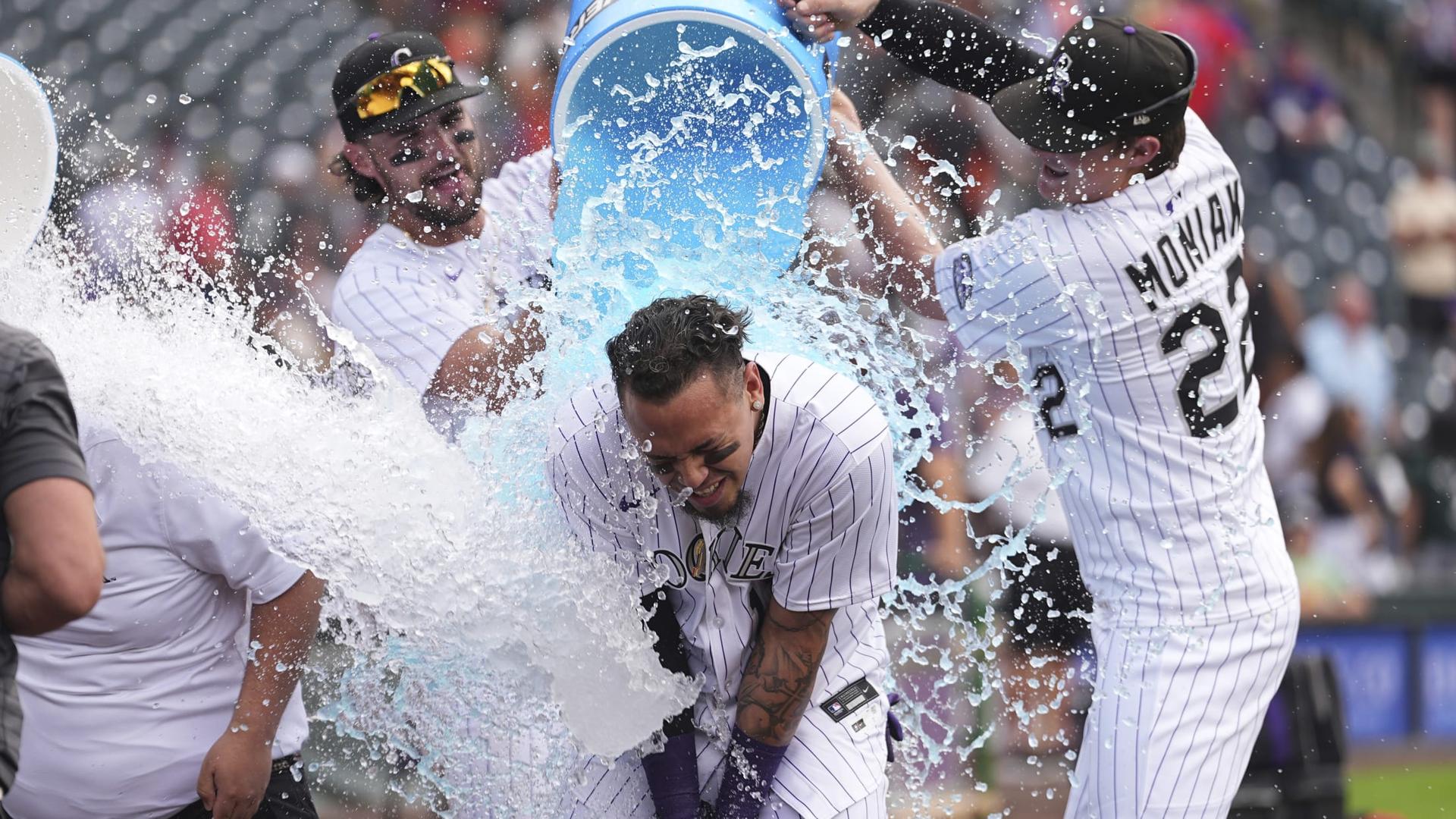 The Rockies celebrate Orlando Arcia's walk-off single