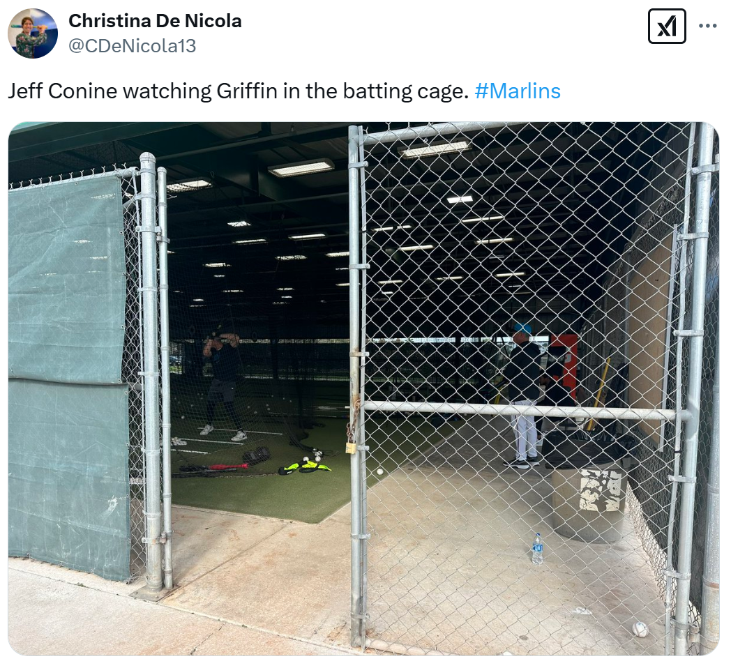 Jeff Conine watches on as his son, Griffin, hits in the cages on Saturday.