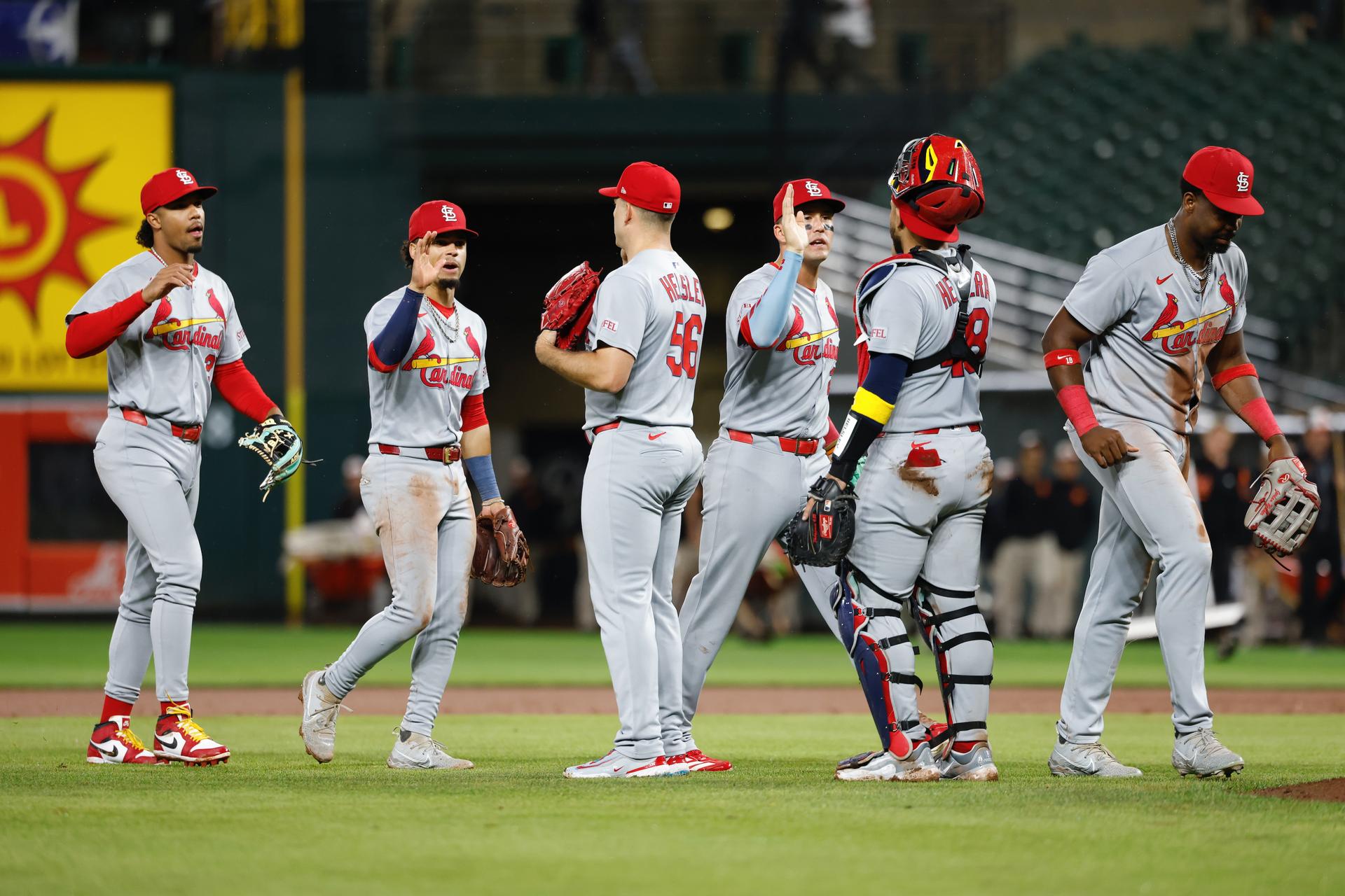 Ryan Helsley high-fives his teammates