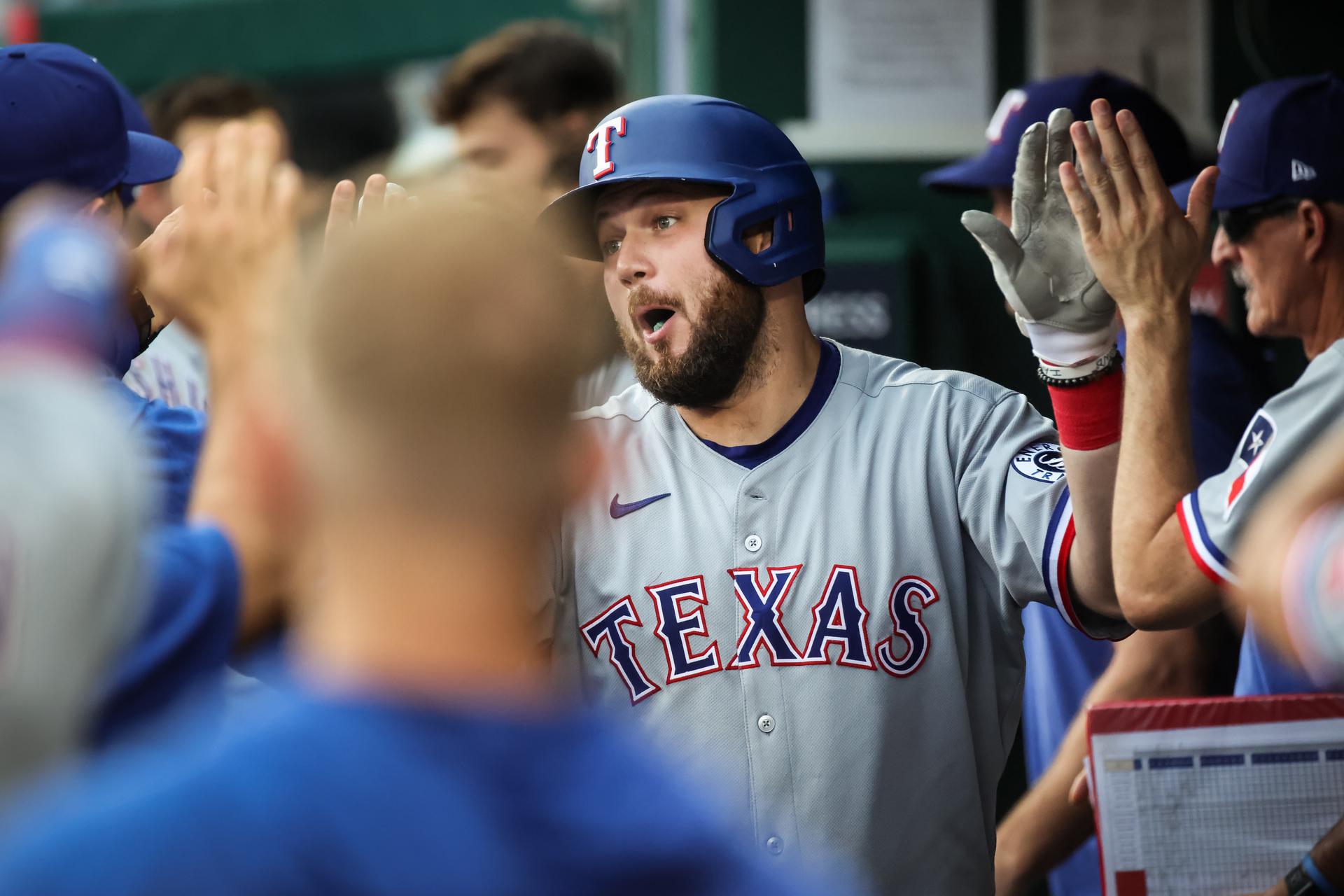 Jake Burger is congratulated by  teammates 