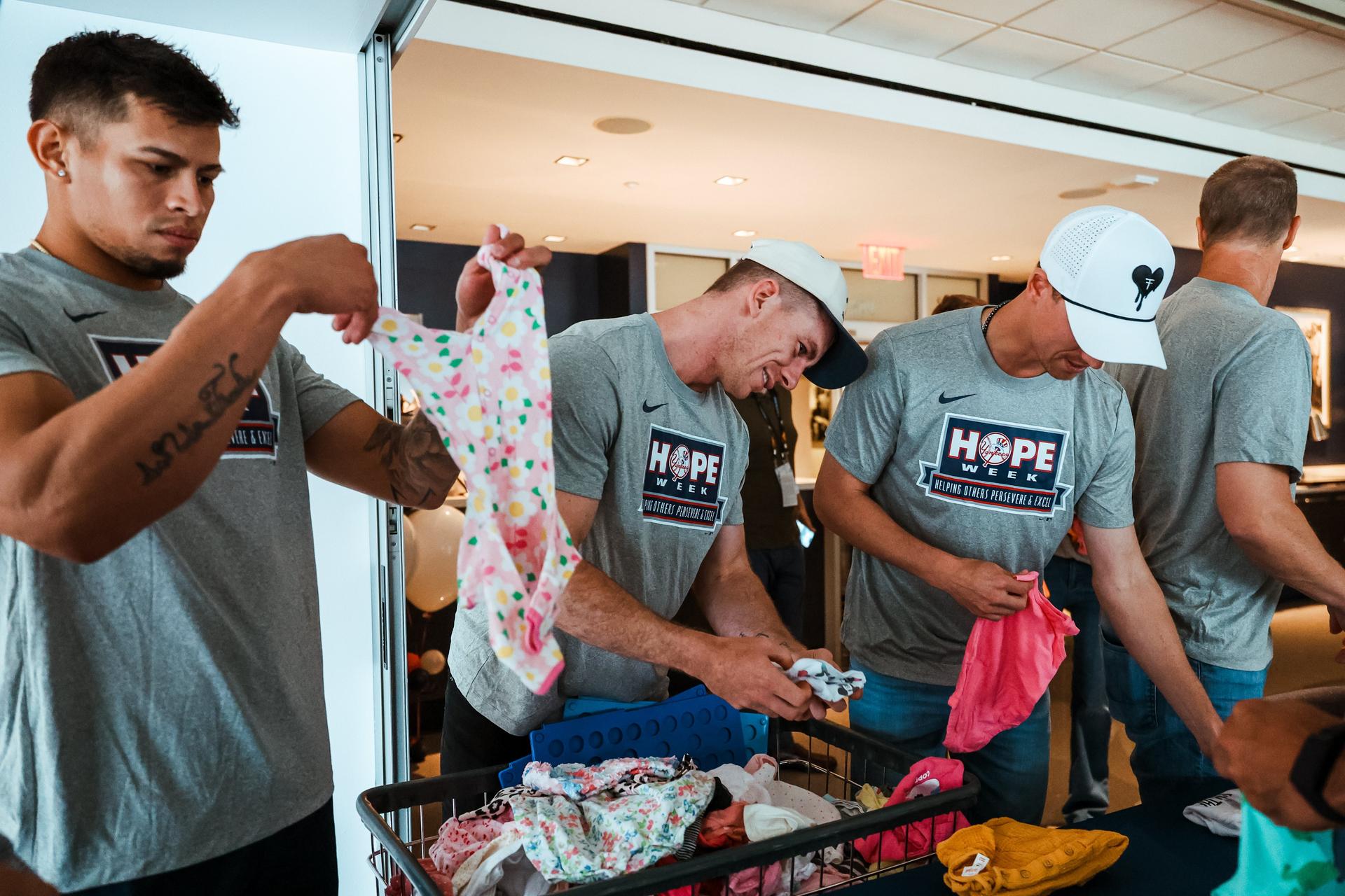 Yankees sort baby clothes during HOPE Week