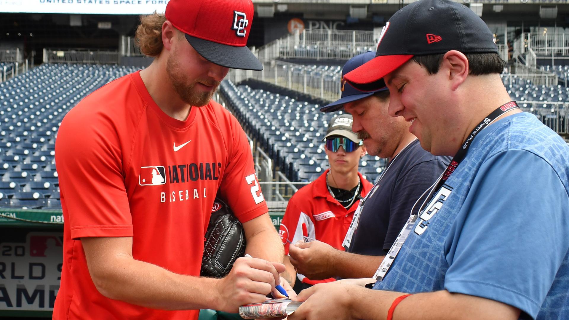 Jake Irvin signs autograph for fans