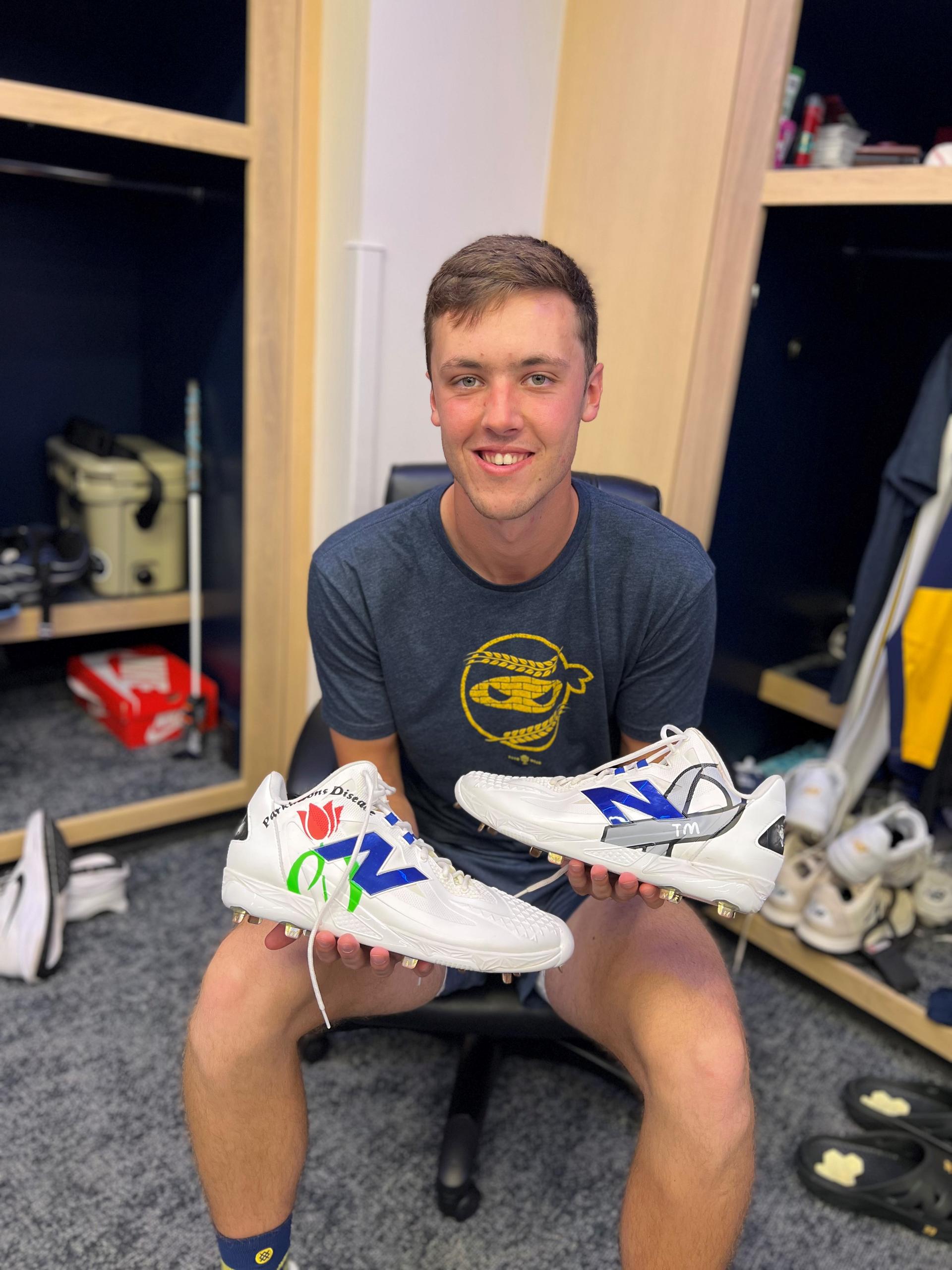 Jacob Misiorowski holds his cleats honoring his father