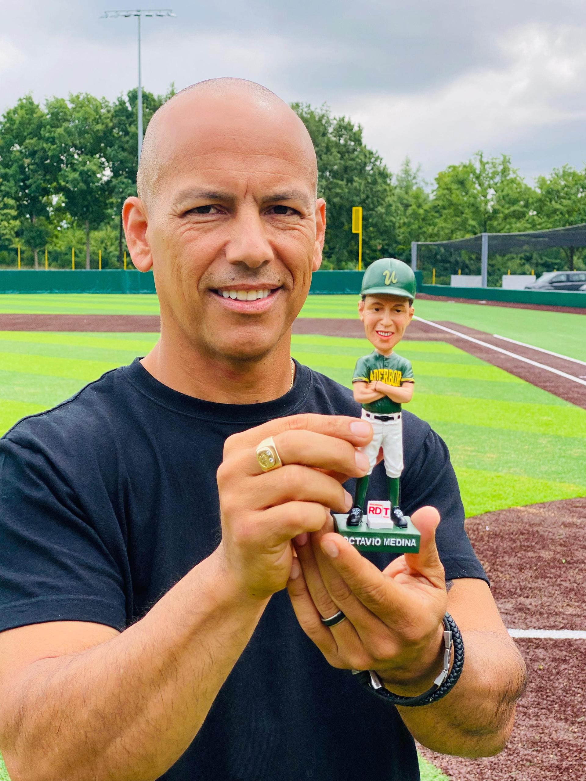 Octavio Medina poses with his bobblehead. 