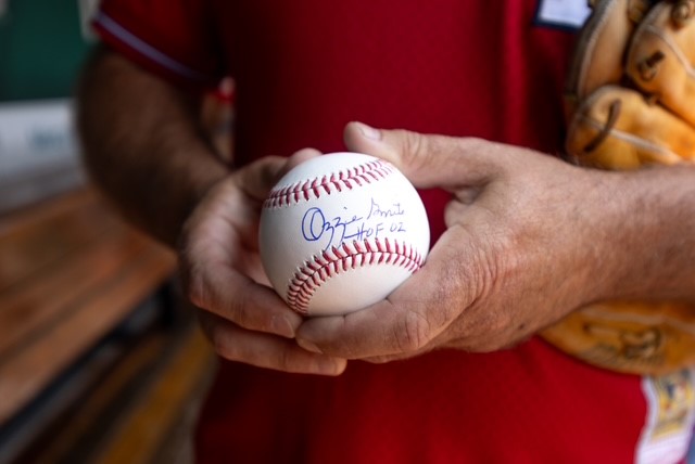 Ozzie autographs a ball for Chad Phelps