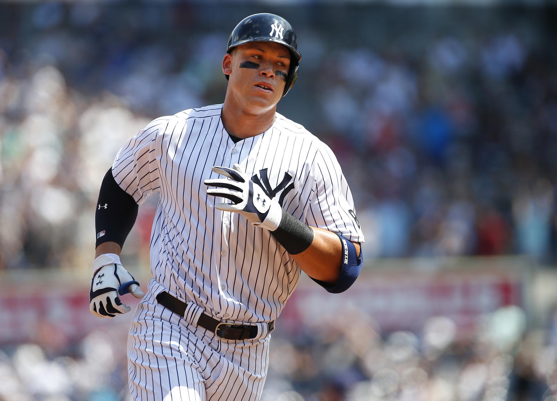 Aaron Judge rounds the bases after his first career homer