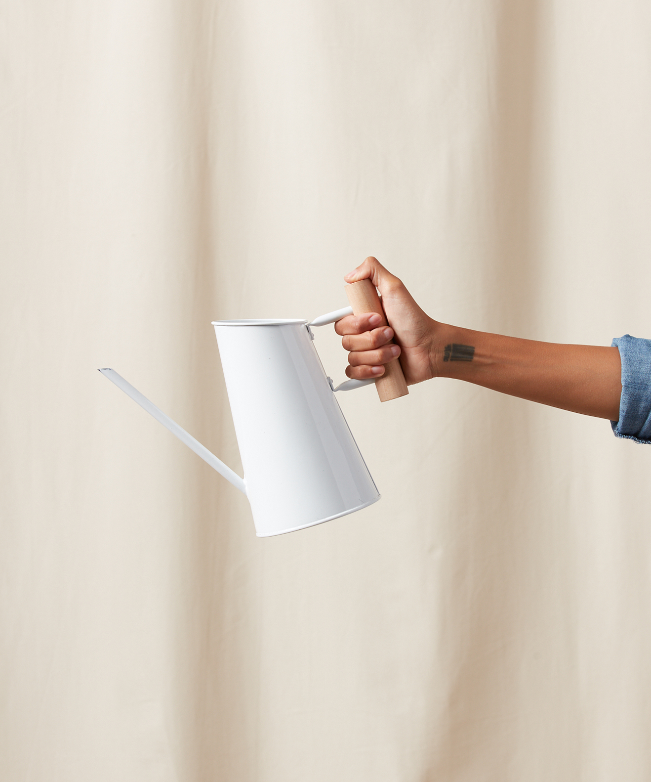 Person holding a Small Watering Can