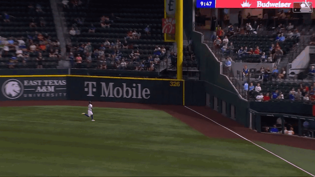 An animated gif of Rangers right fielder Adolis García making a sliding catch