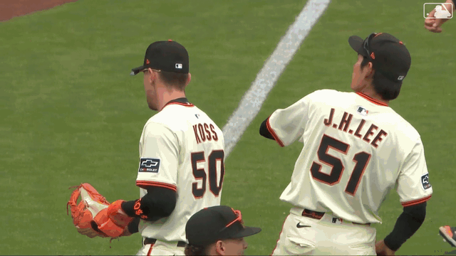 Jung Hoo Lee tosses a ball to a lucky young fan