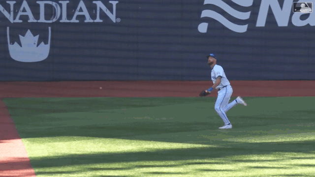 Nathan Lukes crashes into the left-field wall to make a catch