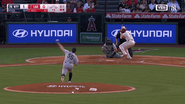 An animated gif of Yankees pitcher Carlos Rodón making a spinning play against the Angels