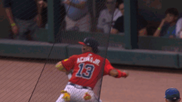 An animated gif of Ronald Acuña Jr. making a throw from deep right field to third base