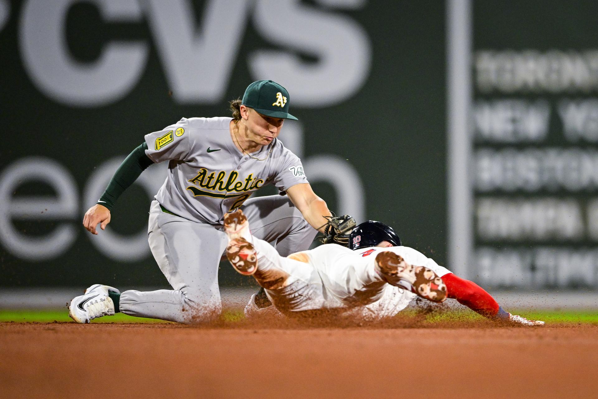 Zack Gelof applies the tag on Trevor Story