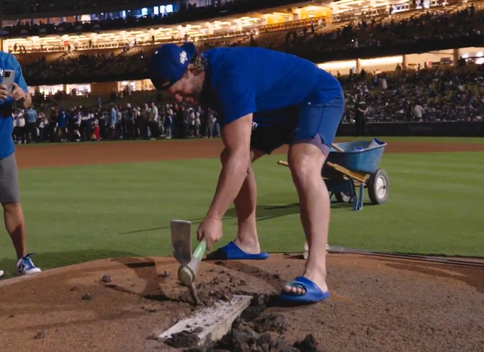 Clayton Kershaw using a pick axe to dislodge the Dodger Stadium pitching rubber