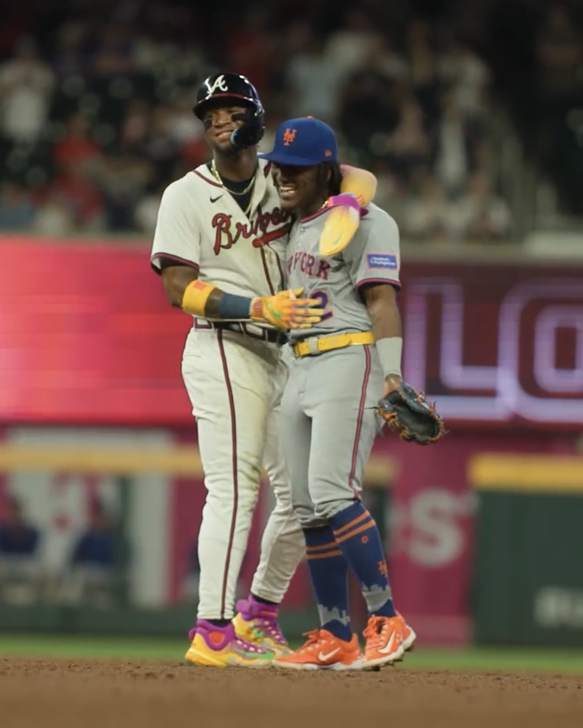Ronald Acuña Jr. and his brother Luisangel embrace on the field during a Braves-Mets game