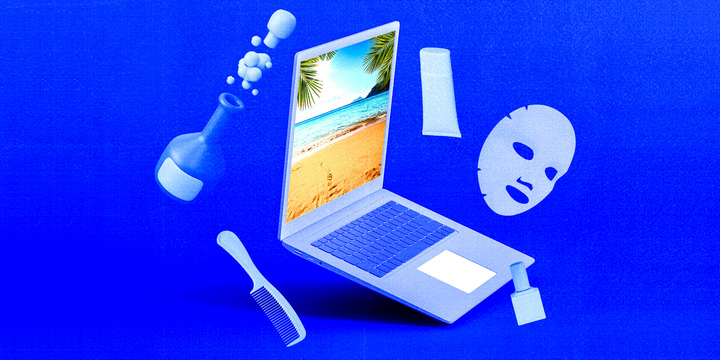 laptop with beauty products around it
