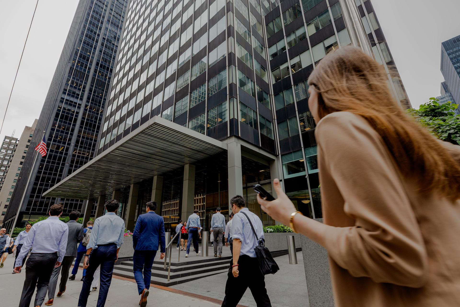 Image of people walking past JP morgan tower outside