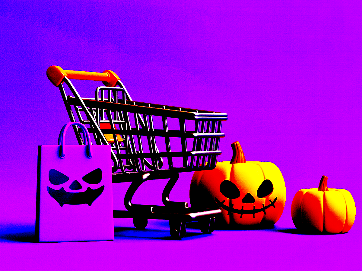 A shopping cart surrounded by pumpkins against a purple background.