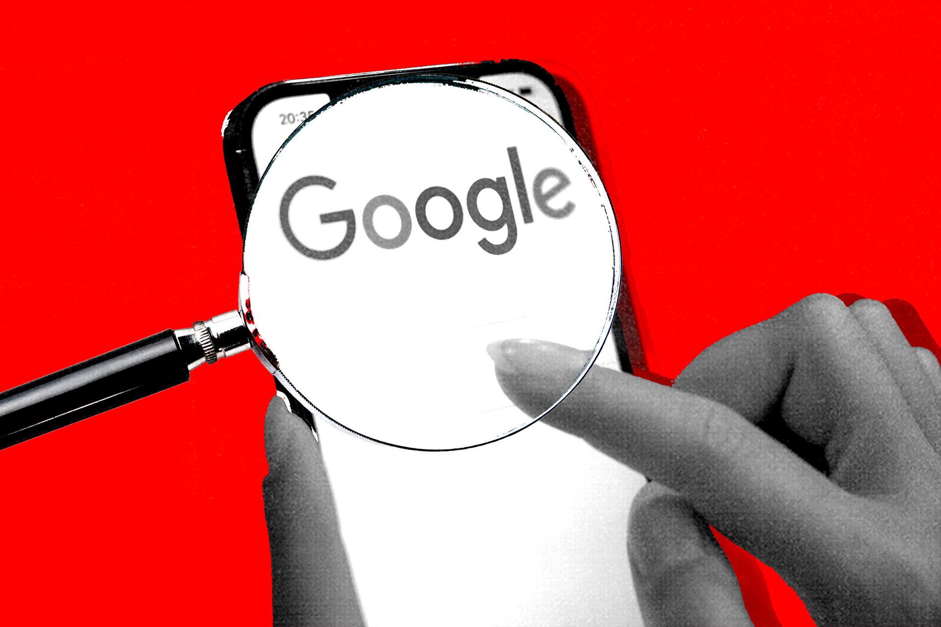 A magnifying glass is held over the Google logo, which is displayed on an iPhone.