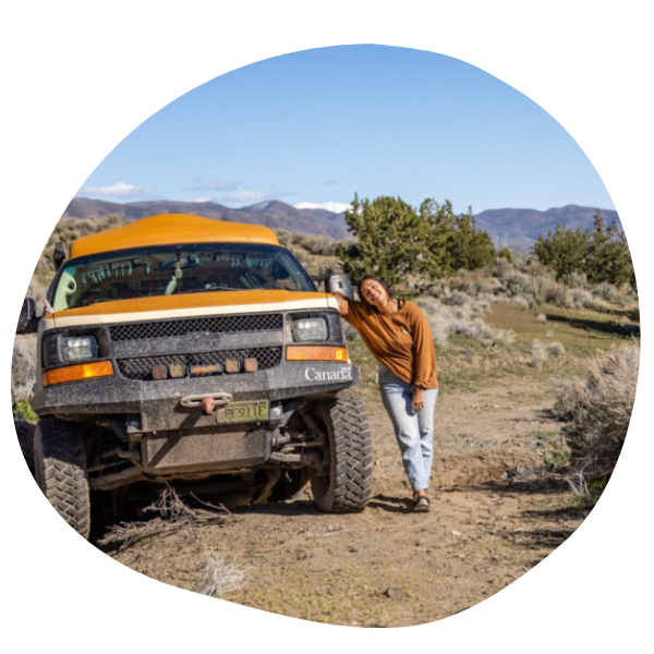 Woman leaning on adventure camper