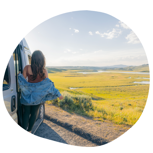 Woman standing outside of camper van