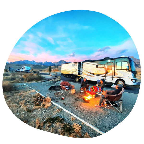 People by campfire outside RV