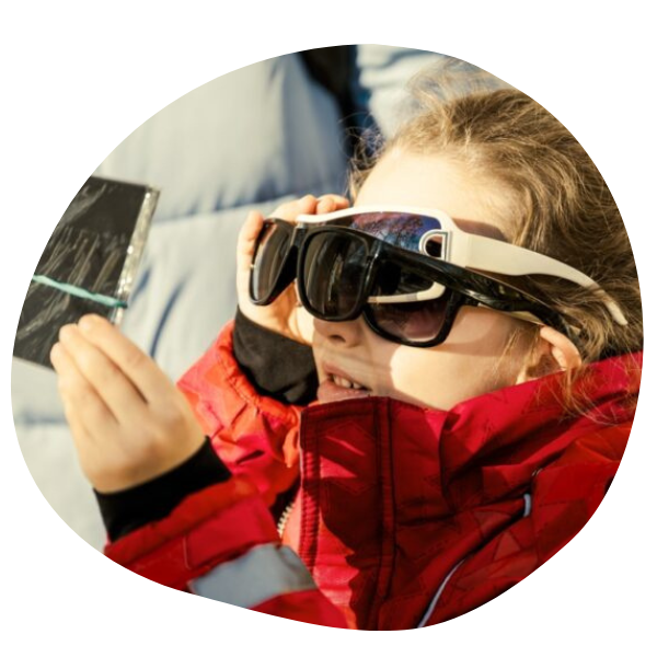 Kid with solar eclipse glasses