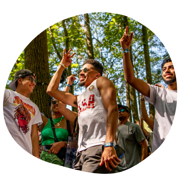 People dancing in woods at festival