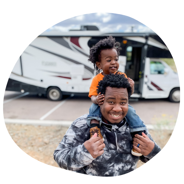 Dad and kid in front of RV
