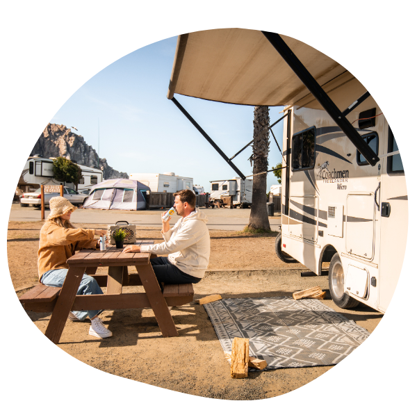 Couple sitting outside RV