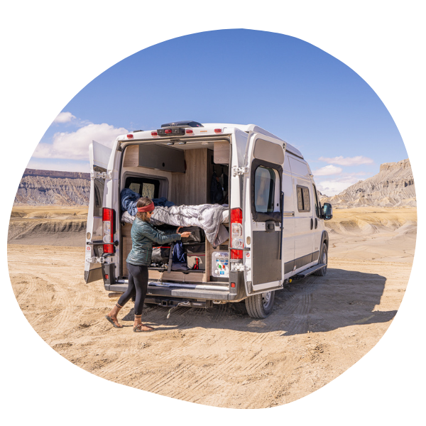 Person putting items in camper van