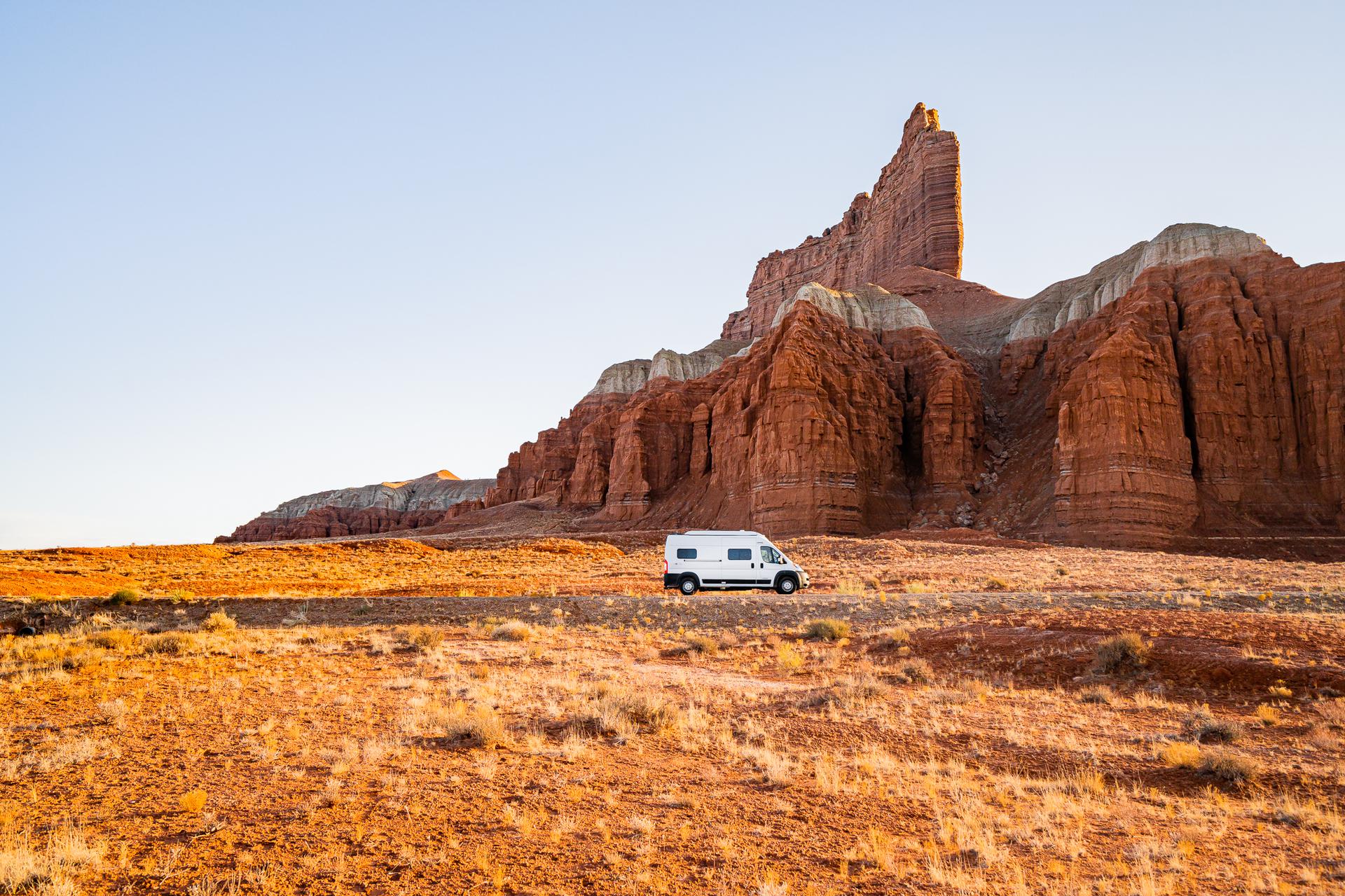 Campervan in the desert with rock formation