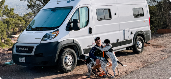 Man and dogs outside of camper van