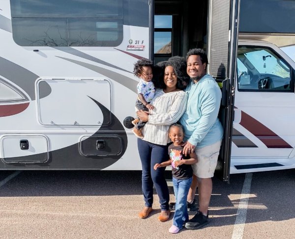Family of 4 in front of RV