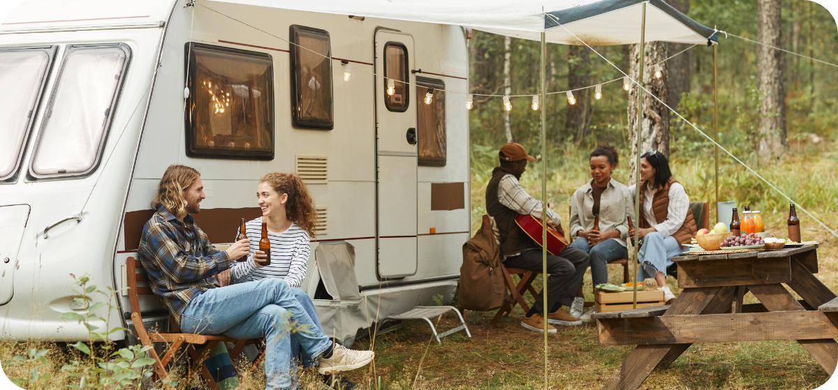 Friends eating outside of RV with Yogi and gang