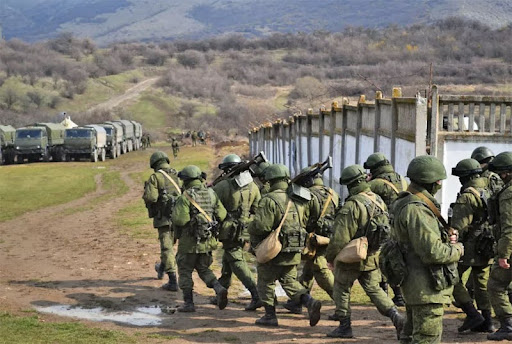 Army Men Marching Towards Trucks